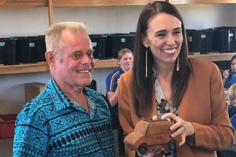 The Pirme Minister with 'Mr King' and the wooden car she made in his woodwork class.