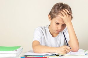 boy with dyslexia struggling to write