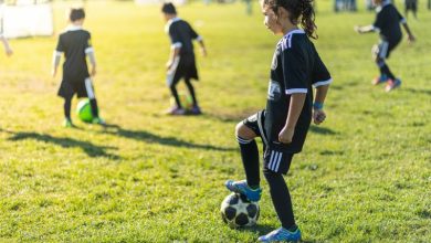 Young female student with soccer ball